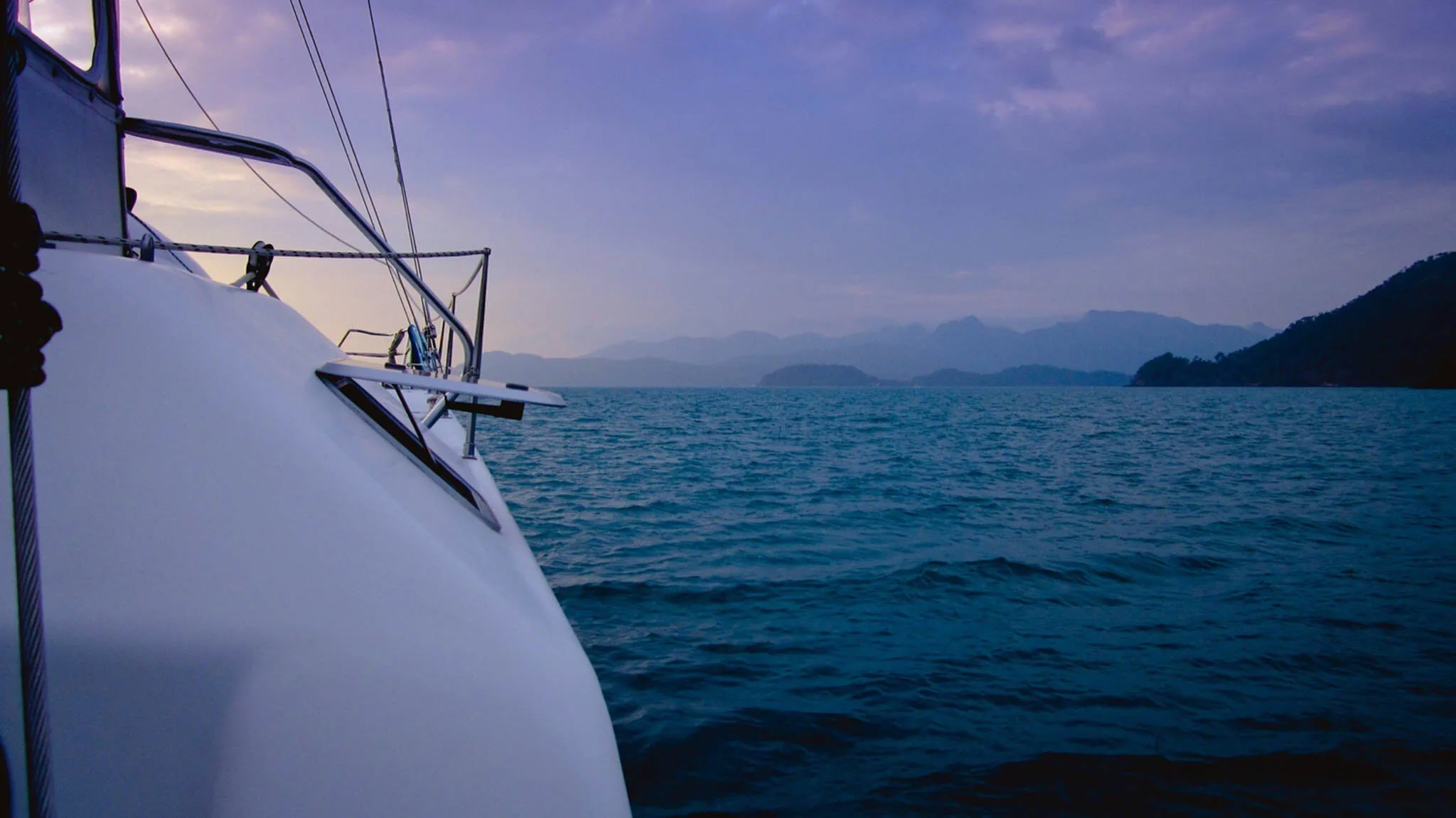 The bow of a catamaran at dusk