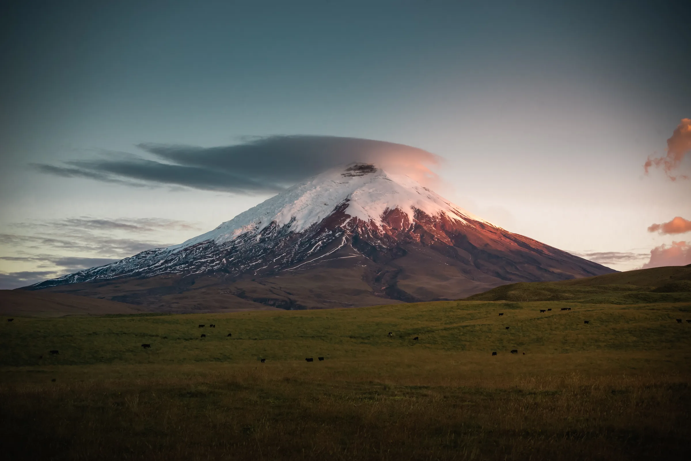 Cotopaxi under a lenticular cloud at dusk