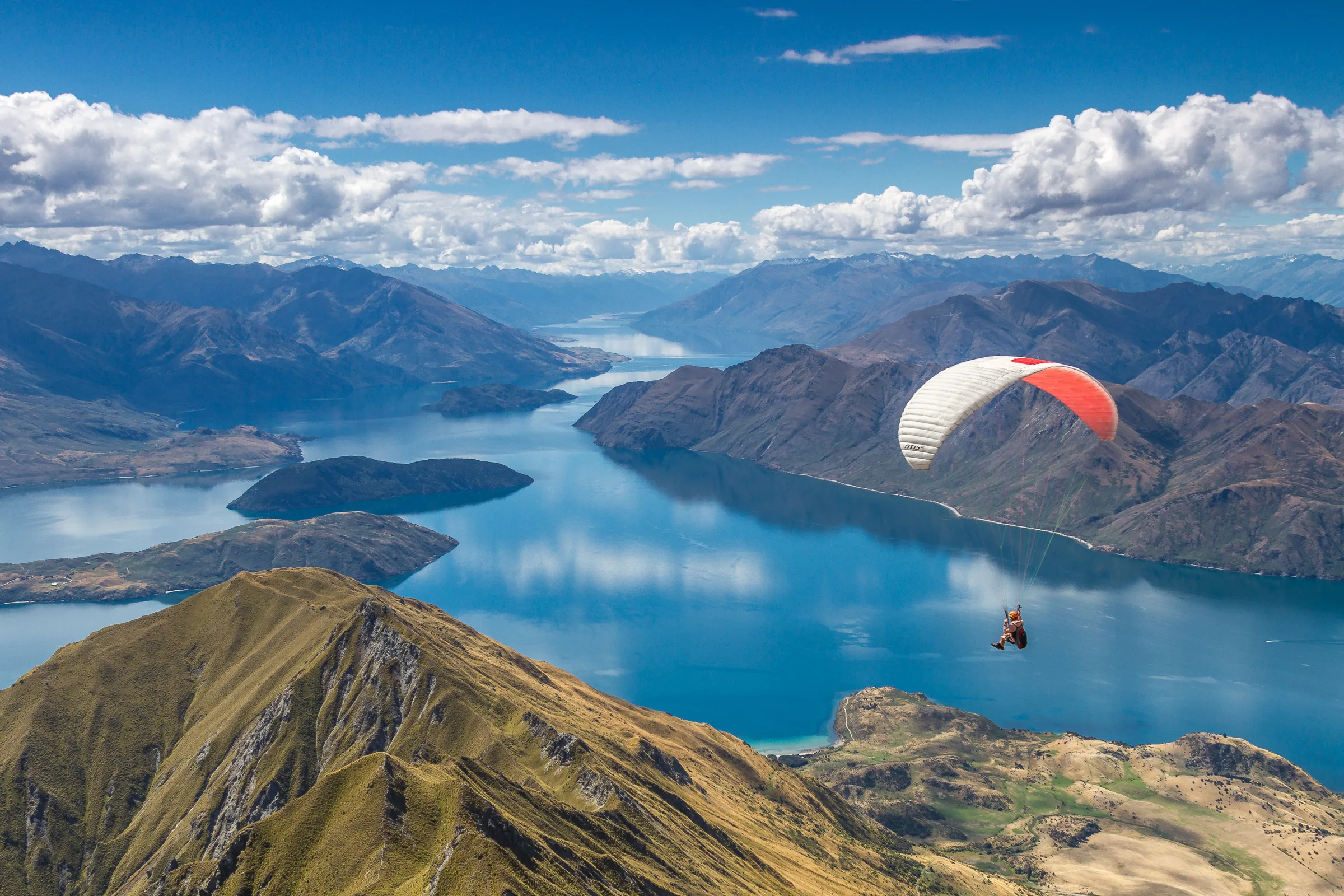 A paraglider over Lake Wanaka from the Roys Peak ridge
