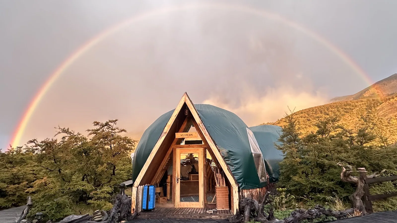 A geodesic dome at EcoCamp Patagonia under a rainbow