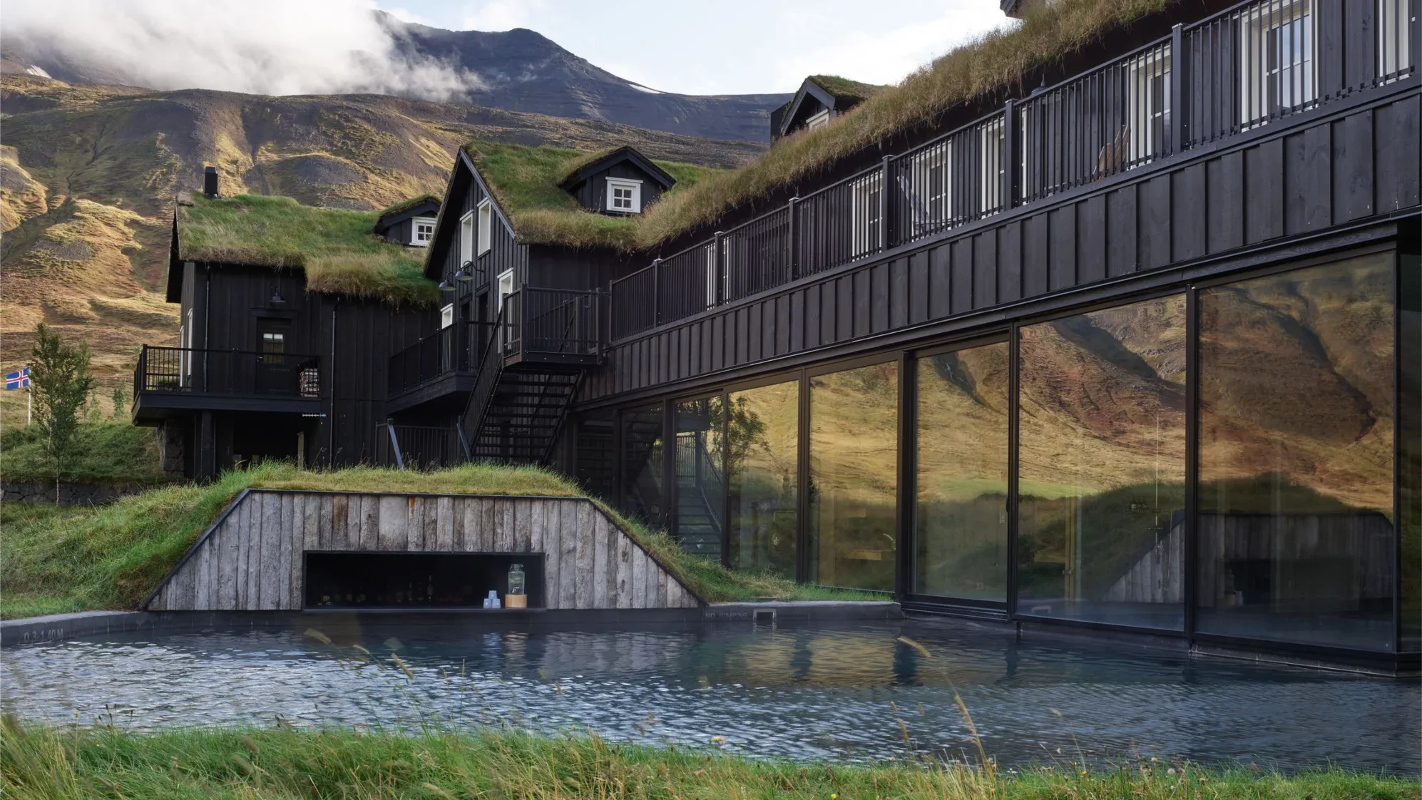 The turf-roofed wing and geothermal pool at Deplar Farm